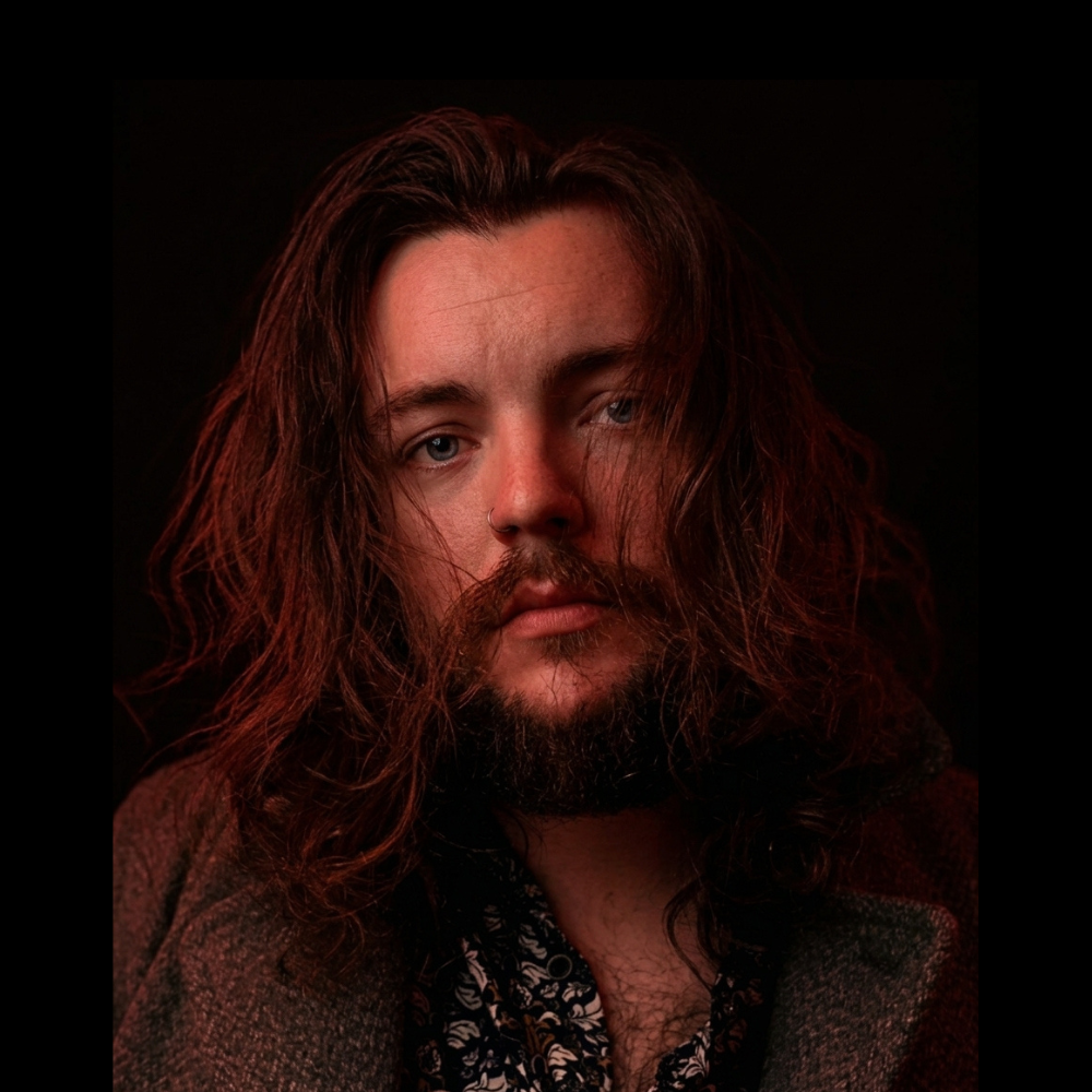 Jake Keane, tarot reader from Liverpool, holding a spread of tarot cards